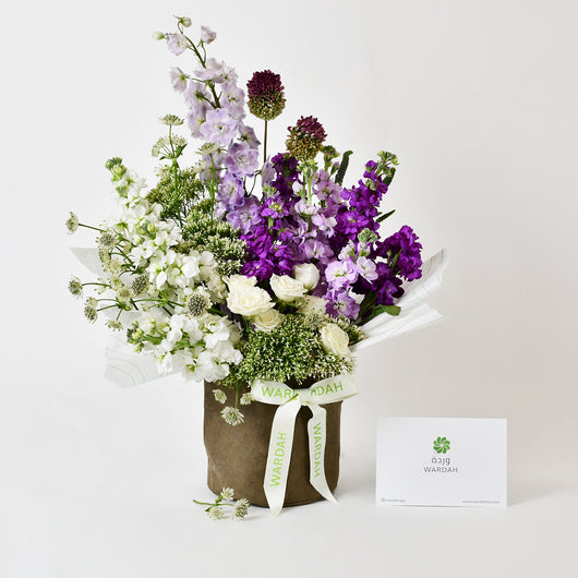 white and purple matthiola arrangement in vase