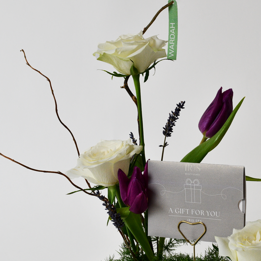 Iris spa gift card with arrangement flowers in a tray