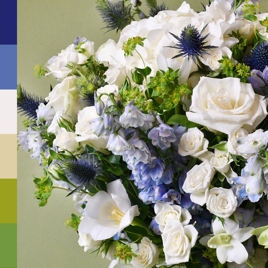 white and blue flower arrangement in a vase