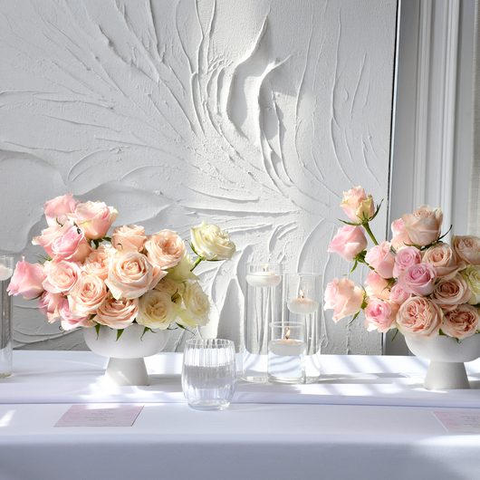 classic roses in white vases table setup