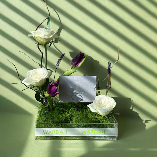 Iris spa gift card with arrangement flowers in a tray