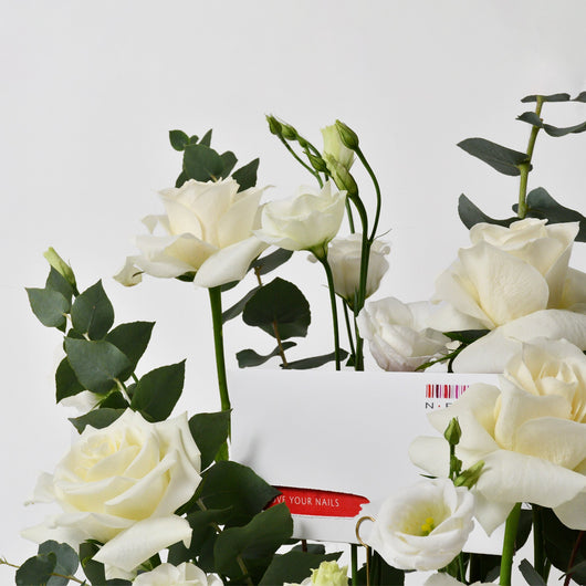 white flowers in a tray with gift card