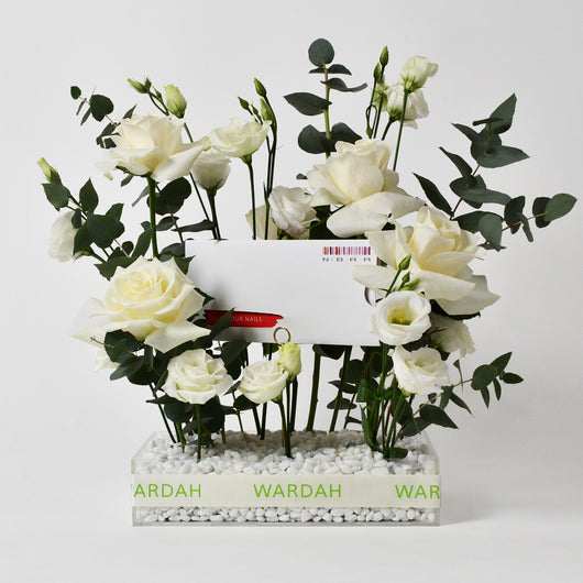 white flowers in a tray with gift card