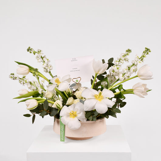 white and green arrangement in a vase