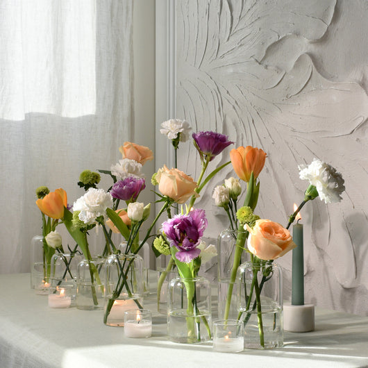 Table escape vases with fresh peach & white flowers 