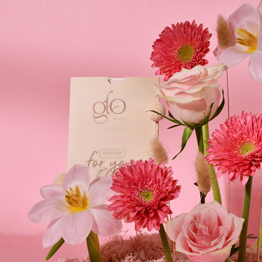 pink flowers in a tray with gift card