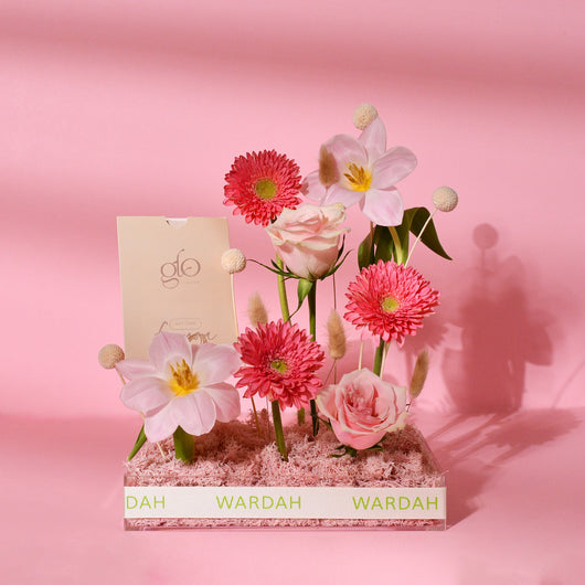 pink flowers in a tray with gift card