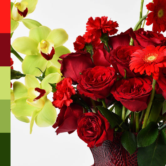 red and green flowers arrangement in red leather vase