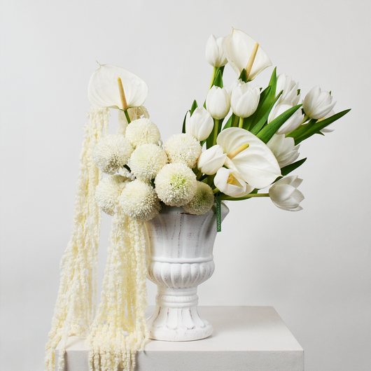 white arrangement in white vase 